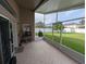 Screened patio with view to the yard with tile flooring and a ceiling fan at 5921 Lake Champlain Dr, Orlando, FL 32829