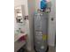 Water heater next to utility sink and storage cabinets in the garage at 5921 Lake Champlain Dr, Orlando, FL 32829