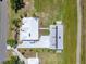 Bird's eye view showing the home and detached garage with solar panels and surroundings at 6555 Bay Tree Ct, St Cloud, FL 34771