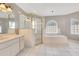 Well-lit bathroom boasts a glass enclosed shower, soaking tub, and double sink vanity at 6555 Bay Tree Ct, St Cloud, FL 34771