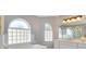 Bright bathroom featuring a soaking tub, glass block window and vanity with ample counter space at 6555 Bay Tree Ct, St Cloud, FL 34771
