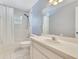 Bathroom with white tile flooring, tub with shower and single sink vanity at 6555 Bay Tree Ct, St Cloud, FL 34771