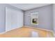 Bedroom featuring a large closet, window view, and light hardwood flooring at 6555 Bay Tree Ct, St Cloud, FL 34771