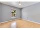 Bedroom featuring light hardwood floors, a ceiling fan, and a large window at 6555 Bay Tree Ct, St Cloud, FL 34771