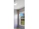 This bedroom has neutral-toned walls, light-colored hardwood floors, a ceiling fan, and an outdoor view at 6555 Bay Tree Ct, St Cloud, FL 34771