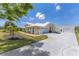 This property boasts a long drive and additional garage or workspace, all set on a lush lawn at 6555 Bay Tree Ct, St Cloud, FL 34771