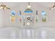 Bright foyer with high ceilings, tile floors, and decorative glass front door creates an inviting entrance at 6555 Bay Tree Ct, St Cloud, FL 34771