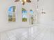 Bright foyer features a decorative glass front door, tile flooring, arched windows, and ceiling fans at 6555 Bay Tree Ct, St Cloud, FL 34771