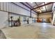 Spacious garage with metal walls, high ceilings, and ample workspace perfect for projects and storage at 6555 Bay Tree Ct, St Cloud, FL 34771