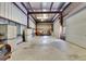 Large garage with metal construction, a roll-up door, offering plenty of room for vehicle storage and workshop space at 6555 Bay Tree Ct, St Cloud, FL 34771