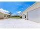 Expansive driveway leads to a sizable garage building with large doors, offering ample storage at 6555 Bay Tree Ct, St Cloud, FL 34771