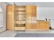 Bright garage features built-in wooden storage cabinets with doors and drawers at 6555 Bay Tree Ct, St Cloud, FL 34771