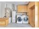 Functional laundry room with updated washer, dryer, water heater and storage cabinets at 6555 Bay Tree Ct, St Cloud, FL 34771