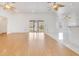 Open concept living area with hardwood floors, ceiling fans, and access to outdoor patio at 6555 Bay Tree Ct, St Cloud, FL 34771