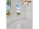 Bright living room featuring tile flooring, an updated ceiling fan, and large windows at 6555 Bay Tree Ct, St Cloud, FL 34771