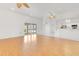 Open concept living area with hardwood floors, ceiling fans, and access to kitchen area at 6555 Bay Tree Ct, St Cloud, FL 34771