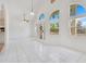 Spacious living area with tile floors, ceiling fans, and multiple arched windows bringing in natural light at 6555 Bay Tree Ct, St Cloud, FL 34771