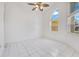 Bright living room featuring tile flooring, an updated ceiling fan, and large windows at 6555 Bay Tree Ct, St Cloud, FL 34771