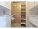 Organized walk-in closet featuring custom shelving, hanging rods, and ample storage space at 6555 Bay Tree Ct, St Cloud, FL 34771