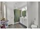 Clean bathroom featuring a white vanity, well-lit mirror, and a shower with a decorative curtain at 685 Overpool Ave, Davenport, FL 33896