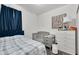 Cozy bedroom furnished with a crib, full bed, and dresser at 685 Overpool Ave, Davenport, FL 33896