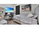 Well-lit bedroom with a modern desk setup, a large television, and a comfortable bed at 685 Overpool Ave, Davenport, FL 33896