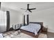 Cozy bedroom with a modern ceiling fan, neutral tones, and stylish furnishings at 685 Overpool Ave, Davenport, FL 33896