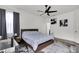 Comfortable bedroom with a plush bed, modern ceiling fan, and ample natural light at 685 Overpool Ave, Davenport, FL 33896