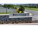 The BellaViva at Westside neighborhood sign in brick and stone with lush landscaping at 685 Overpool Ave, Davenport, FL 33896
