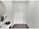 Bright entryway with white door, wood floors, marble side table and golden decor at 685 Overpool Ave, Davenport, FL 33896