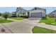 Charming single-story home with a manicured lawn and driveway at 685 Overpool Ave, Davenport, FL 33896