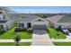 Inviting single-Gathering home featuring a well-manicured lawn and two-car garage at 685 Overpool Ave, Davenport, FL 33896