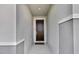 The covered entryway features a raised panel mahogany front door with smart lock at 685 Overpool Ave, Davenport, FL 33896