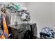 Efficient laundry room featuring sleek black Samsung washer and dryer units with overhead storage at 685 Overpool Ave, Davenport, FL 33896