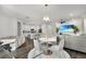 Open concept living area with modern furnishings and a view of the kitchen, creating an inviting space at 685 Overpool Ave, Davenport, FL 33896