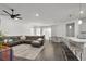 Open-concept living room with hard surface floors, white walls, and a ceiling fan at 685 Overpool Ave, Davenport, FL 33896