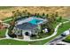 Community pool area featuring a clubhouse, lounge chairs, palm trees, and lush landscaping in a tranquil setting at 685 Overpool Ave, Davenport, FL 33896
