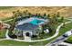 Community pool area featuring a clubhouse, lounge chairs, palm trees, and lush landscaping in a tranquil setting at 685 Overpool Ave, Davenport, FL 33896