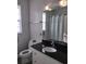 Bright bathroom featuring black countertop and a shower at 8101 Coconut Palm Way # 303, Kissimmee, FL 34747