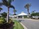 Attractive clubhouse with a white roof, landscaping, and palm trees providing a resort style feel at 8101 Coconut Palm Way # 303, Kissimmee, FL 34747