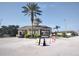 Community entrance gatehouse with palm trees, attractive landscaping and marked entry lanes for visitors at 8101 Coconut Palm Way # 303, Kissimmee, FL 34747