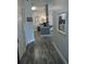 Hallway leading to kitchen with modern decor, dark wood floors, and a hall closet at 8101 Coconut Palm Way # 303, Kissimmee, FL 34747