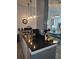 Kitchen with black countertops and stainless steel sink with view to the living room at 8101 Coconut Palm Way # 303, Kissimmee, FL 34747