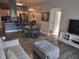 Open living area flows to the dining room and kitchen, featuring hardwood floors and natural light at 8101 Coconut Palm Way # 303, Kissimmee, FL 34747