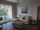 Comfortable living room with a sectional sofa, ottoman, sliding glass doors to balcony with an outdoor view at 8101 Coconut Palm Way # 303, Kissimmee, FL 34747