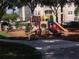 Community playground with colorful play equipment and visible playground rules sign at 8101 Coconut Palm Way # 303, Kissimmee, FL 34747