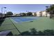 Well-maintained tennis courts with surrounding greenery and residential buildings in the background at 8101 Coconut Palm Way # 303, Kissimmee, FL 34747