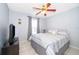 Cozy bedroom with tile floors, a ceiling fan, and a window allowing plenty of natural light at 812 Adour Dr, Kissimmee, FL 34759