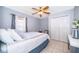 Well-lit bedroom featuring tile flooring, a window with curtains, a closet, and a ceiling fan at 812 Adour Dr, Kissimmee, FL 34759