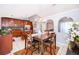Dining room with wood table set, chandelier, and view of kitchen through arched partition at 812 Adour Dr, Kissimmee, FL 34759